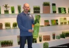 Johan Vlot (Voges) with a post order packaging for orchids in his hands and shop ready packaging solutions in the back of the booth.